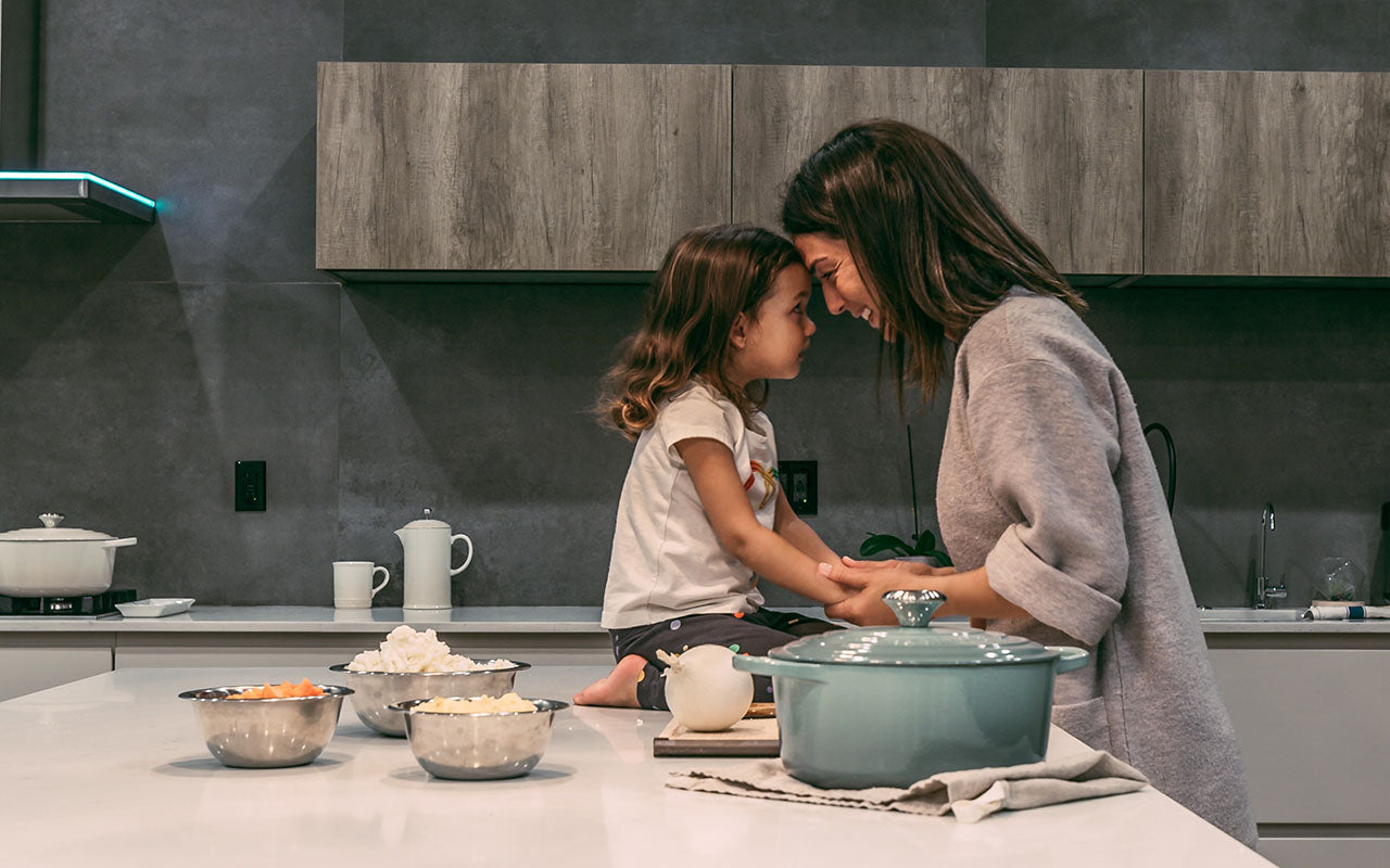 mom and daughter on kitchen counter about to cook